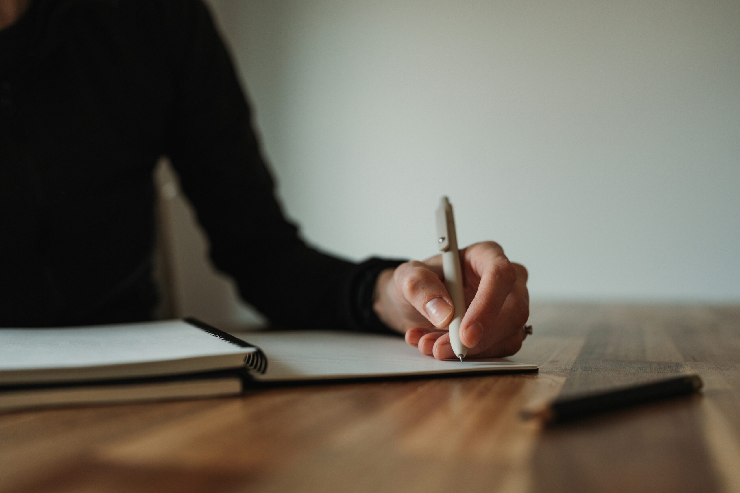Woman writing on paper with pen
